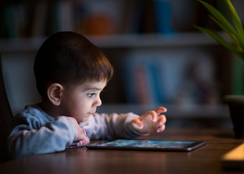 boy staring at tablet